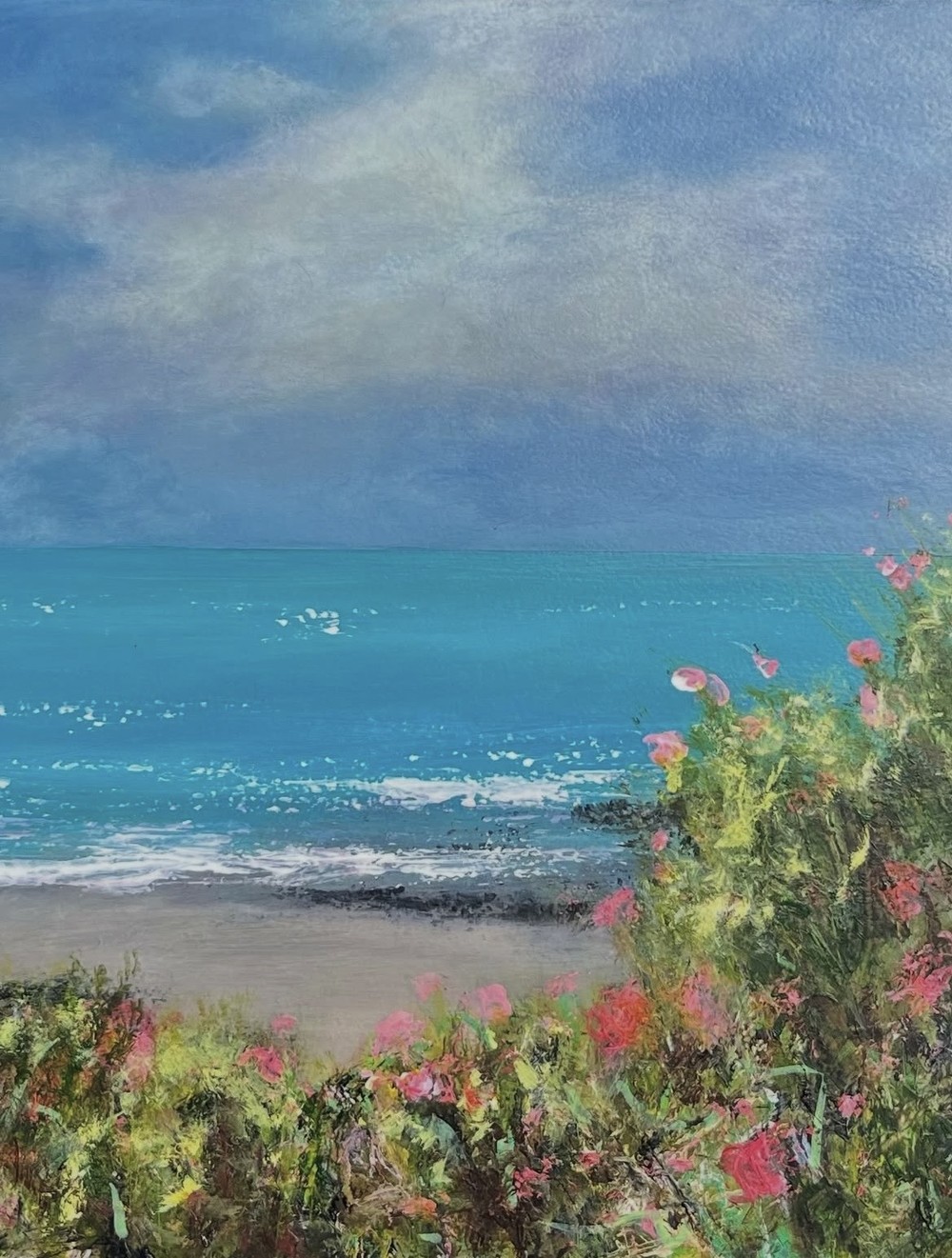 Painting of a turquoise sea seen through bushes of pink wildflowers on a sandy shore